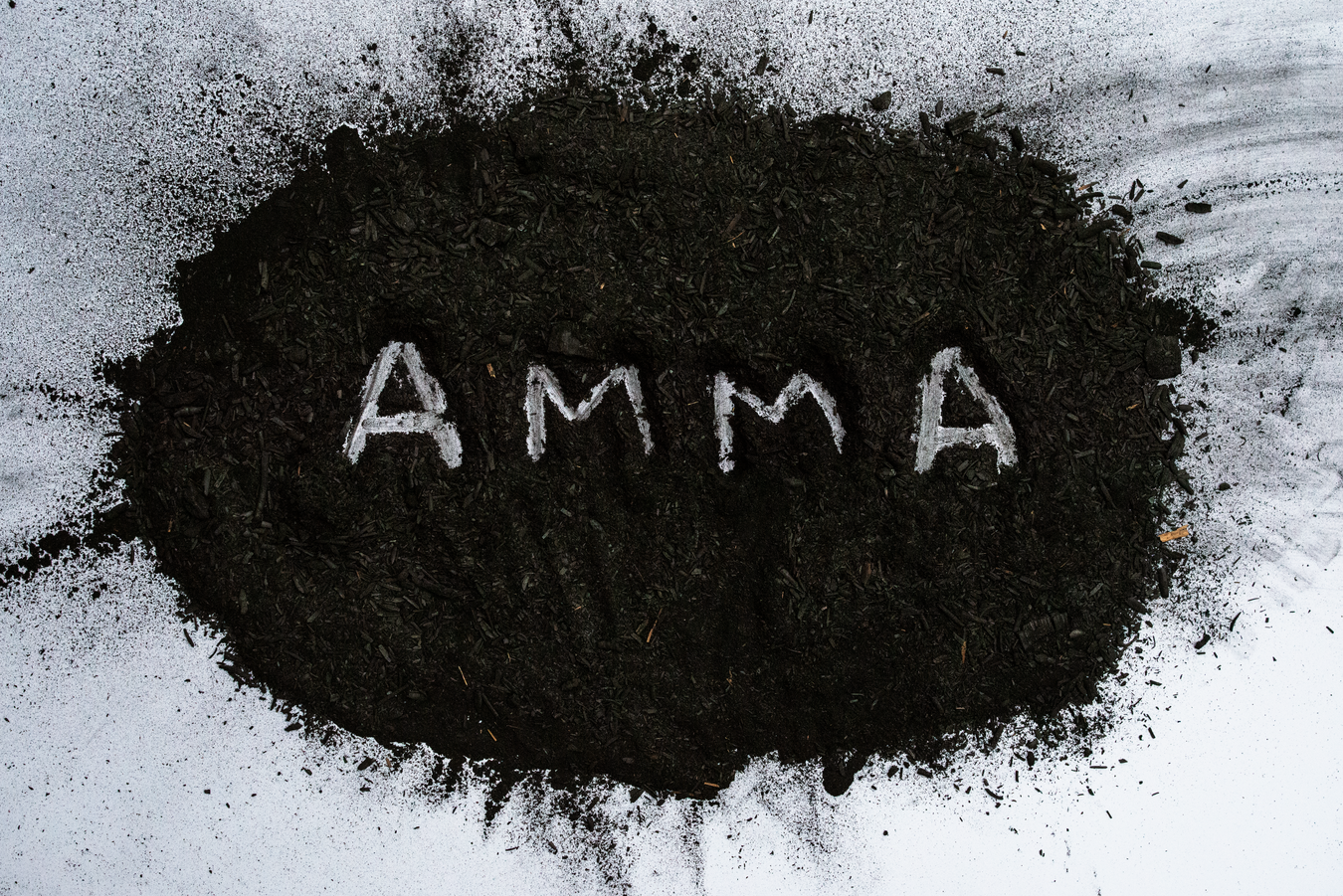 "Amma" marked into a pile of sugarcane ash