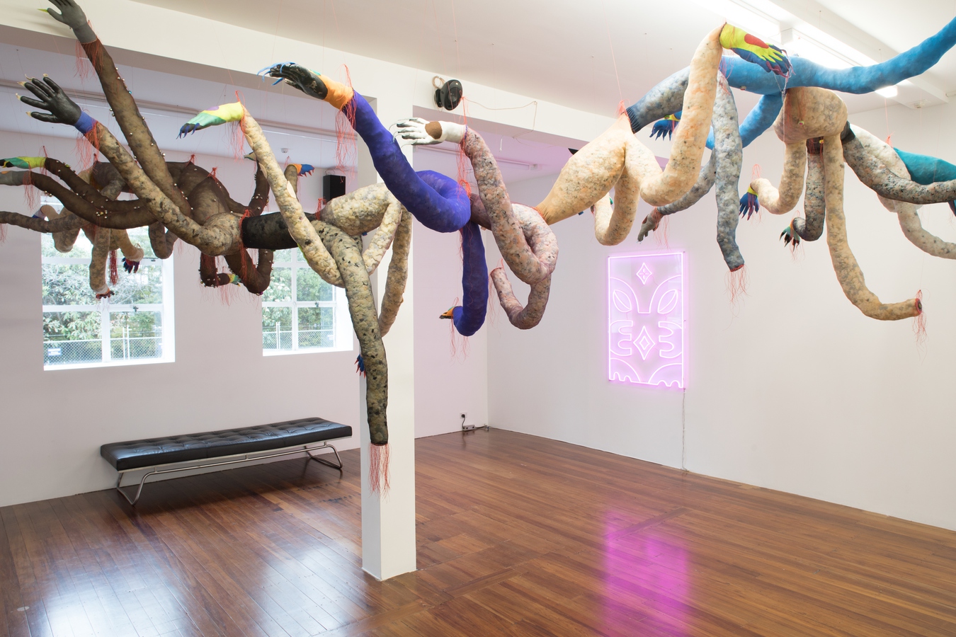 Image: Tyrone Te Waa, Fleapit (installation view), 2023. Stockings, work gloves, fabric, thread, bells, foam chips, wool. Photo by Janneth Gil.