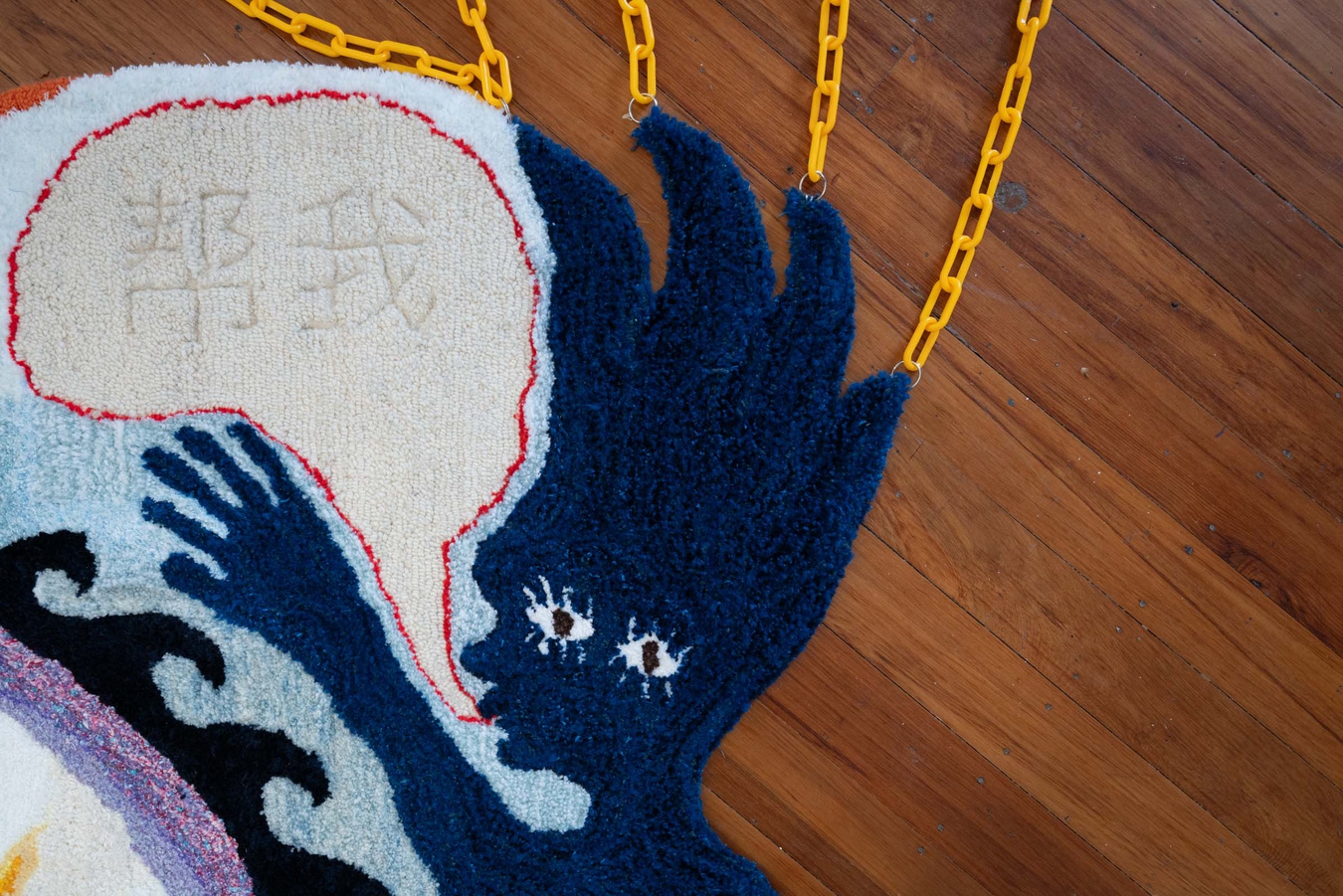 Ruby Chang-Jet White, 回口 (the reply) (detail), 2024. Recycled yarn, mixed chain, ceramic, video, bells, heart charm. Photo by Bri Lawrence.