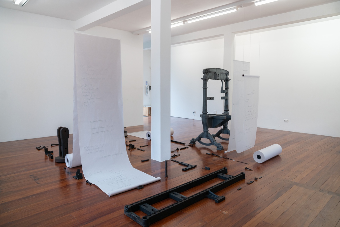 Tamsen Hopkinson, Crimson and Clover, 2025. 1869 Hopkinson & Cope Albion press, woodentypeset, tracing paper, newsprint, silver Poscamarkers, aluminium tube, AM radio. Photo by Bri Lawrence.