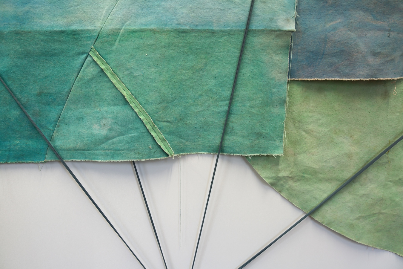 Image: Emma Fitts, From heat to translucence / your mineral touch (installation view), 2023. Weathered canvas, felted wool, aluminium and wooden rods, fabric ties. Photo by Amy Weng.