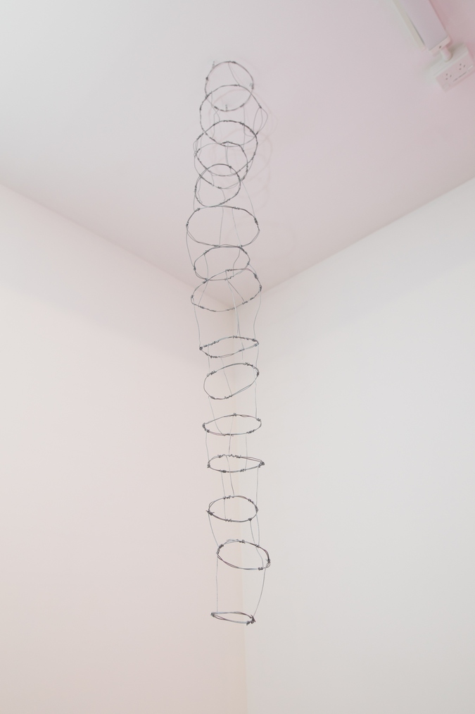 Image: AJ Fata, Hīnaki Taniwha Hikuroa (installation view), 2023. Two parts: wire and silver thread. Photo by Janneth Gil.
