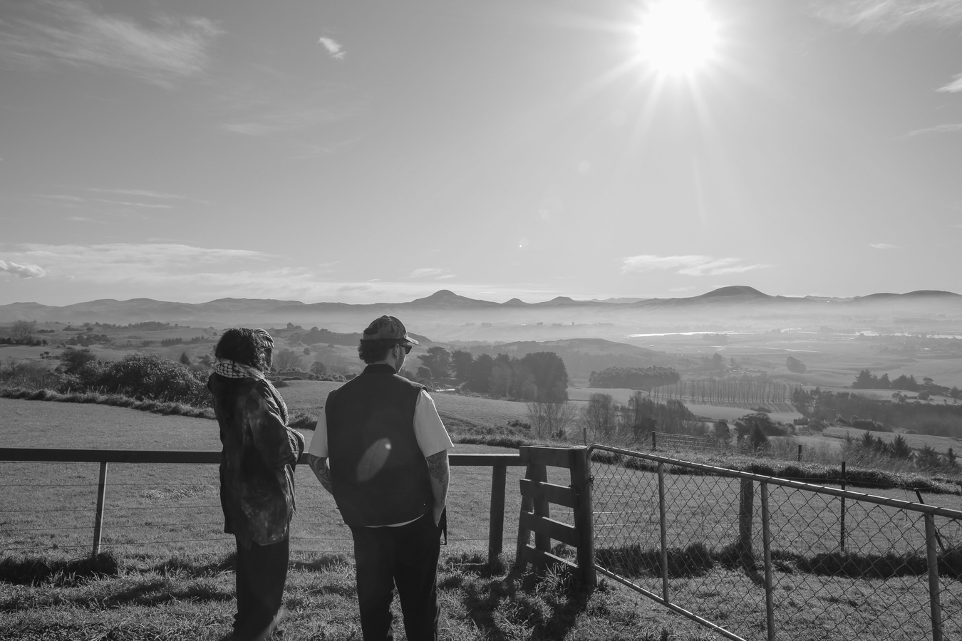 Artists Bri Leone-Rhea Lawrence and Aidan Taira Geraghty looking over Karitane.